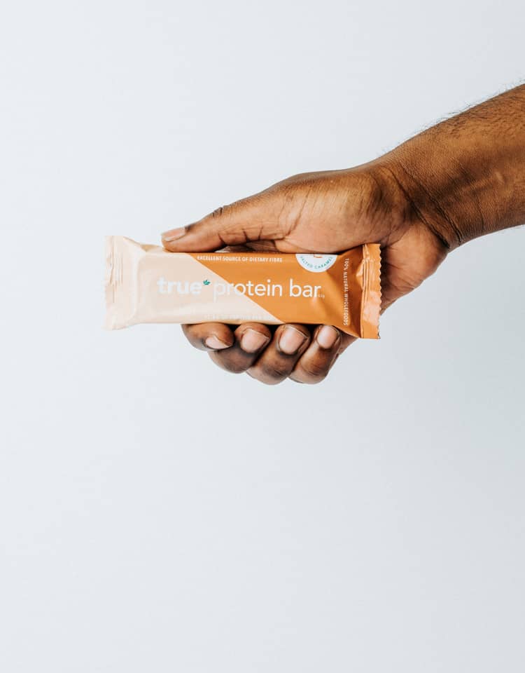 Hand Holding True Protein Bar